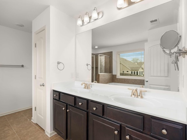 3029 Alan Dr, Spring Hill, TN 37174 - bathroom with a stall shower, double vanity, tile patterned flooring, and baseboards