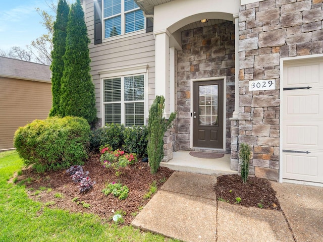 3029 Alan Dr, Spring Hill, TN 37174 - view of exterior entry with stone siding and a garage