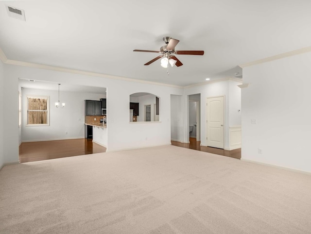 3029 Alan Dr, Spring Hill, TN 37174 - unfurnished living room featuring dark carpet, a ceiling fan, crown molding, and baseboards