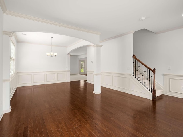 3029 Alan Dr, Spring Hill, TN 37174 - empty room featuring plenty of natural light, arched walkways, a decorative wall, wood finished floors, and wainscoting