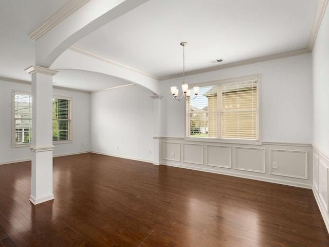 3029 Alan Dr, Spring Hill, TN 37174 - unfurnished dining area featuring decorative columns, a chandelier, arched walkways, dark wood-style floors, and ornamental molding