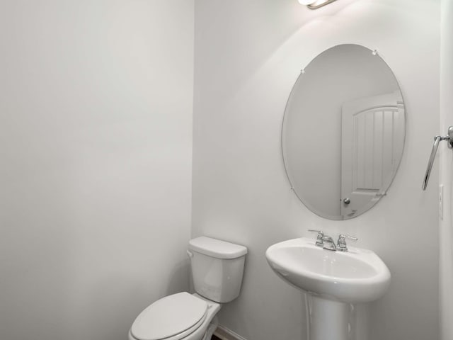 3029 Alan Dr, Spring Hill, TN 37174 - half bath with a sink, toilet, and baseboards