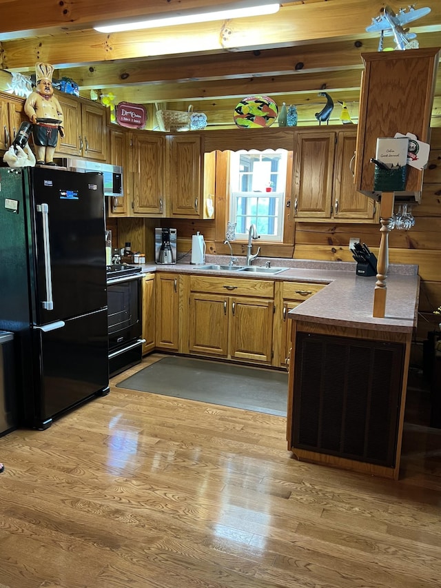 225 Bill Hunter Rd, Celina, TN 38551 - kitchen featuring freestanding refrigerator, range, a sink, and brown cabinets