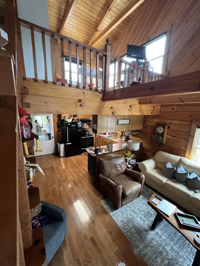225 Bill Hunter Rd, Celina, TN 38551 - living room with wooden walls, plenty of natural light, wood finished floors, wood ceiling with exposed beams, and high vaulted ceiling