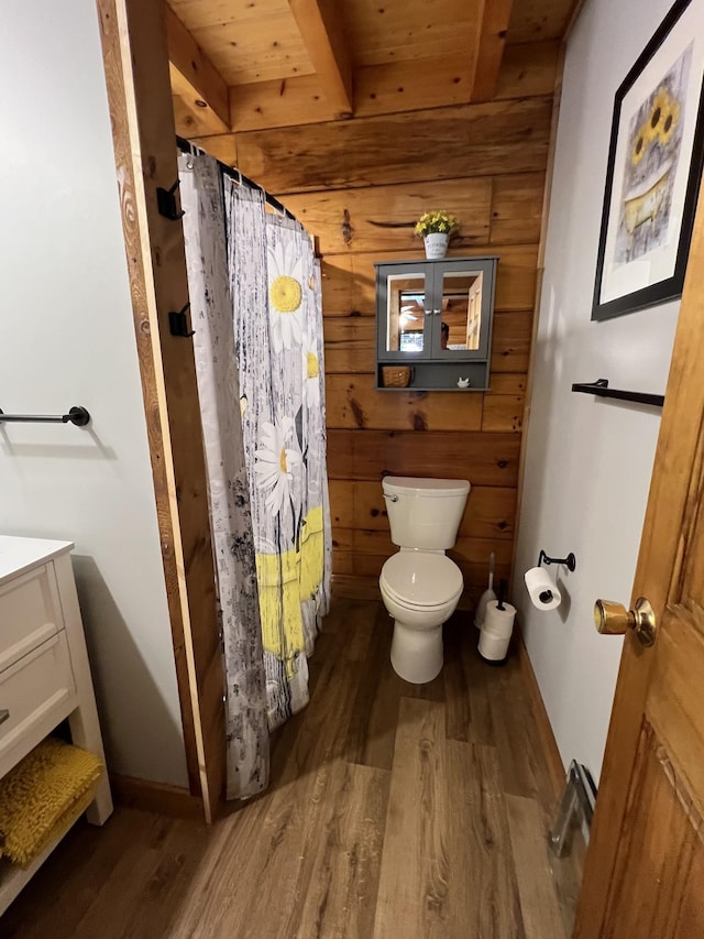 225 Bill Hunter Rd, Celina, TN 38551 - bathroom featuring wood finished floors, toilet, wood walls, a shower with shower curtain, and vanity