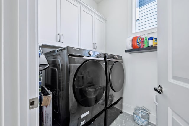 2043 Nathaniel Rd, Franklin, TN 37064 - laundry area featuring separate washer and dryer, cabinet space, baseboards, and tile patterned flooring