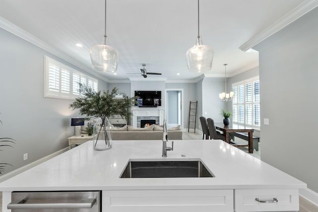 2043 Nathaniel Rd, Franklin, TN 37064 - kitchen featuring a sink, open floor plan, ornamental molding, a warm lit fireplace, and dishwasher