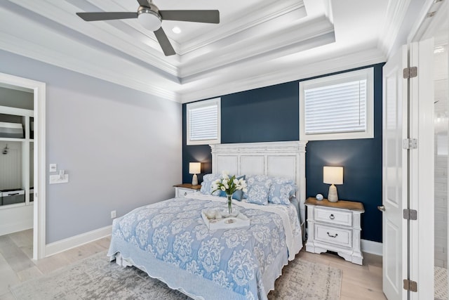 2043 Nathaniel Rd, Franklin, TN 37064 - bedroom with a tray ceiling, ornamental molding, baseboards, light wood-style flooring, and ceiling fan