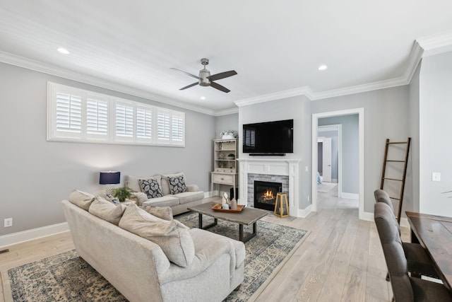 2043 Nathaniel Rd, Franklin, TN 37064 - living area with a ceiling fan, light wood-type flooring, baseboards, ornamental molding, and a glass covered fireplace