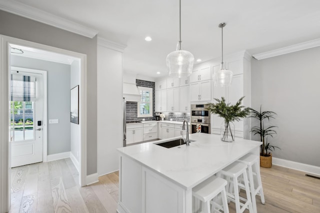 2043 Nathaniel Rd, Franklin, TN 37064 - kitchen with a sink, light wood-style floors, double oven, crown molding, and tasteful backsplash
