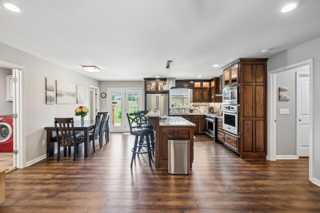 200 Lindsey Hollow Rd, Gallatin, TN 37066 - kitchen featuring high end appliances, recessed lighting, dark wood-style floors, a breakfast bar area, and glass insert cabinets
