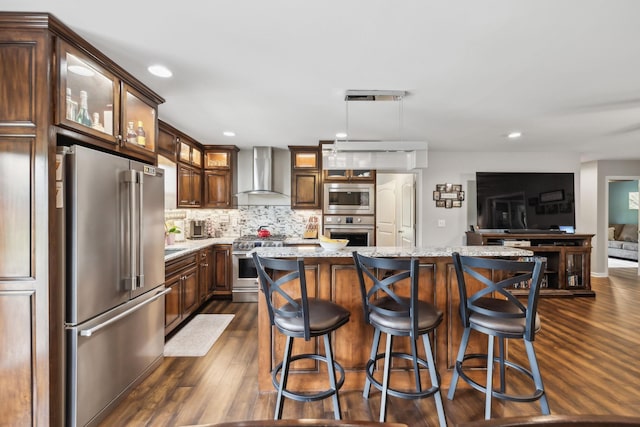 200 Lindsey Hollow Rd, Gallatin, TN 37066 - kitchen featuring high quality appliances, wall chimney exhaust hood, dark wood finished floors, tasteful backsplash, and a kitchen island