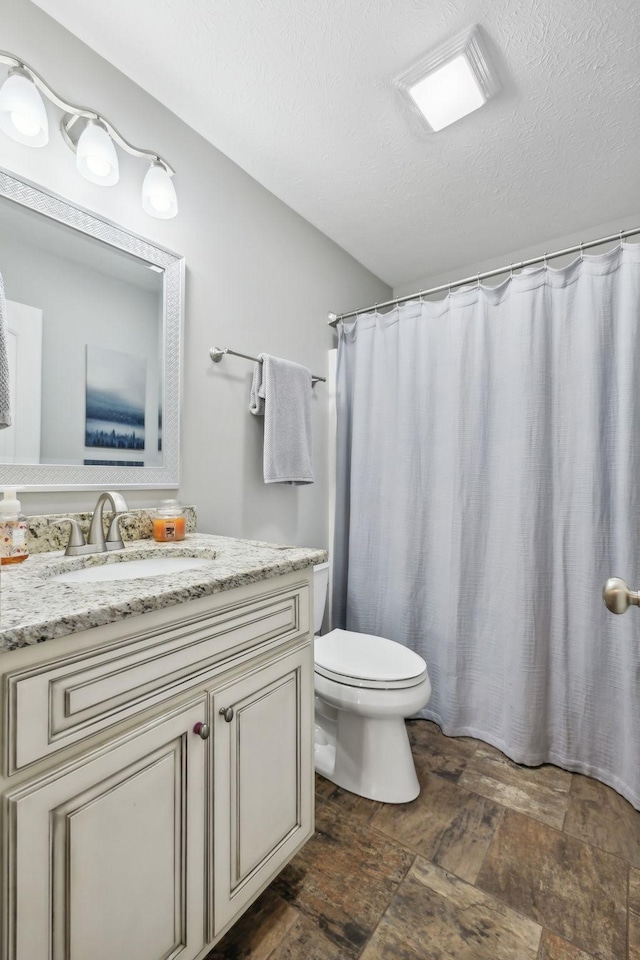 200 Lindsey Hollow Rd, Gallatin, TN 37066 - full bath featuring toilet, stone finish flooring, vanity, a textured ceiling, and a shower with curtain