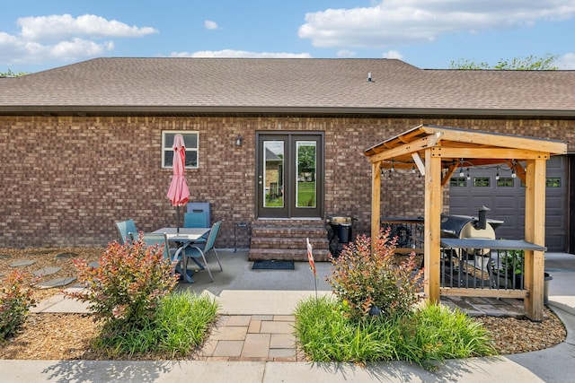 200 Lindsey Hollow Rd, Gallatin, TN 37066 - back of house featuring a shingled roof, french doors, brick siding, a patio area, and entry steps