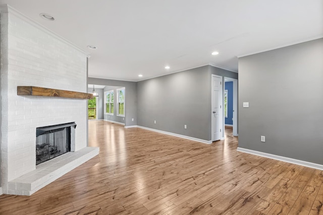 1054 Cragfront Est Loop, Gallatin, TN 37066 - unfurnished living room with crown molding, a fireplace, baseboards, light wood-style floors, and recessed lighting