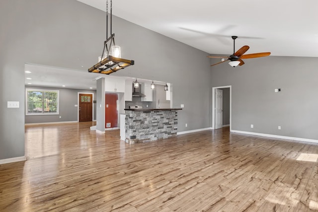 1054 Cragfront Est Loop, Gallatin, TN 37066 - unfurnished living room with high vaulted ceiling, ceiling fan, light wood finished floors, and baseboards