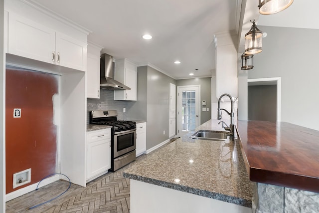 1054 Cragfront Est Loop, Gallatin, TN 37066 - kitchen featuring stainless steel gas range oven, wall chimney exhaust hood, a sink, baseboards, and white cabinetry