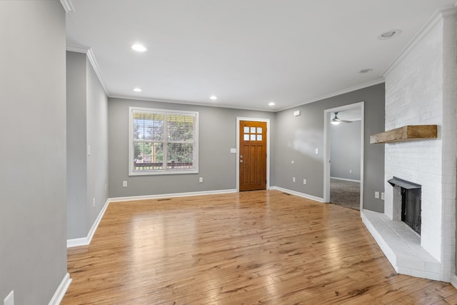1054 Cragfront Est Loop, Gallatin, TN 37066 - entryway featuring crown molding, a fireplace, light wood-style floors, a ceiling fan, and baseboards