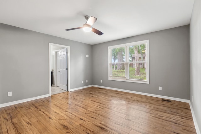 1054 Cragfront Est Loop, Gallatin, TN 37066 - unfurnished bedroom with wood finished floors, baseboards, ceiling fan, and connected bathroom