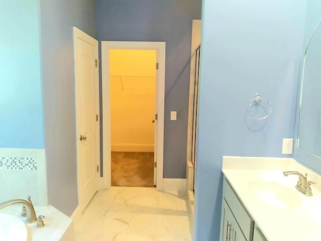 168 Cobbler Cir, Hendersonville, TN 37075 - bathroom with vanity, marble finish floors, a spacious closet, a garden tub, and baseboards