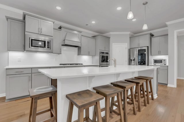 1815 Humphreys Gln, Spring Hill, TN 37174 - kitchen with appliances with stainless steel finishes, gray cabinets, crown molding, custom range hood, and decorative backsplash