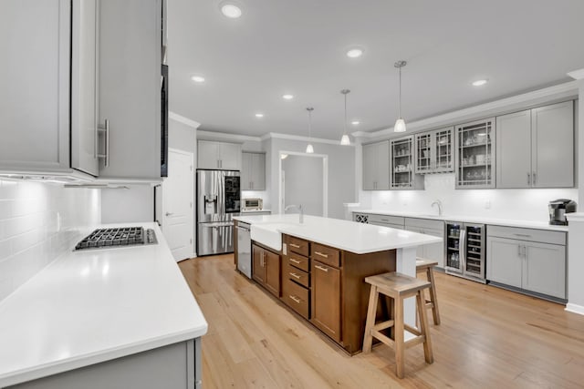1815 Humphreys Gln, Spring Hill, TN 37174 - kitchen featuring appliances with stainless steel finishes, wine cooler, a sink, backsplash, and crown molding