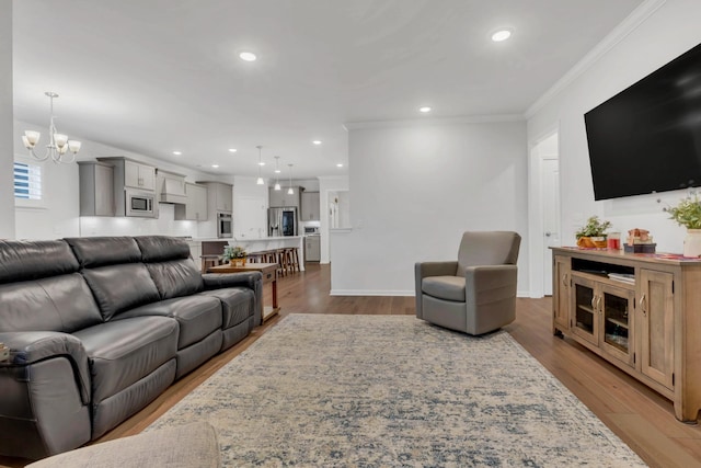 1815 Humphreys Gln, Spring Hill, TN 37174 - living room featuring ornamental molding, a chandelier, light wood-style floors, recessed lighting, and baseboards