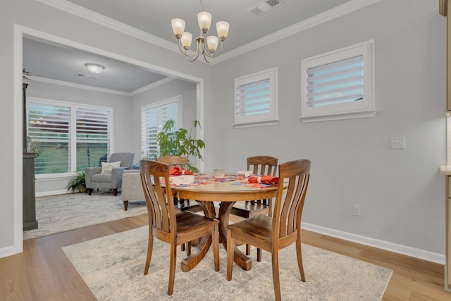 1815 Humphreys Gln, Spring Hill, TN 37174 - dining area with light wood finished floors, crown molding, a chandelier, and baseboards