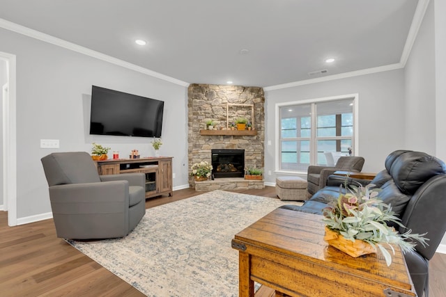 1815 Humphreys Gln, Spring Hill, TN 37174 - living area featuring ornamental molding, wood finished floors, a stone fireplace, baseboards, and recessed lighting
