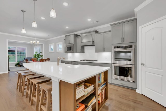1815 Humphreys Gln, Spring Hill, TN 37174 - kitchen with stainless steel appliances, gray cabinetry, crown molding, a kitchen bar, and a sink
