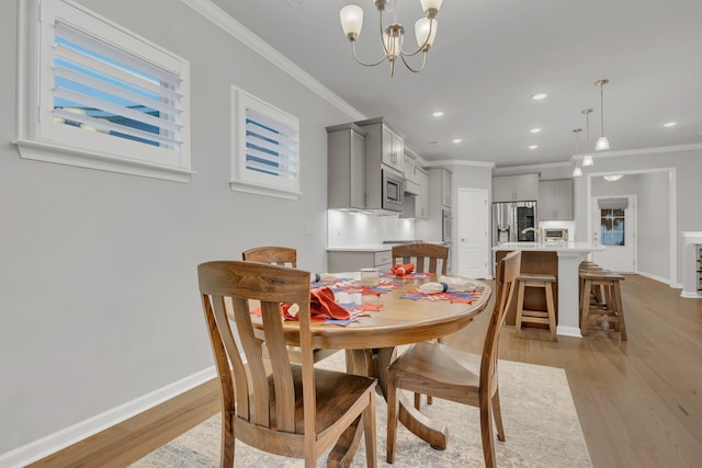 1815 Humphreys Gln, Spring Hill, TN 37174 - dining space with crown molding, a chandelier, light wood finished floors, baseboards, and recessed lighting