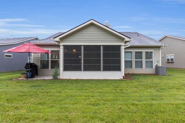 1815 Humphreys Gln, Spring Hill, TN 37174 - rear view of house featuring a yard, central AC, a sunroom, and a shingled roof