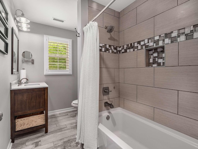 7119 Littlejohn Ln, Fairview, TN 37062 - bathroom featuring shower / bath combination with curtain, wood finished floors, vanity, toilet, and baseboards