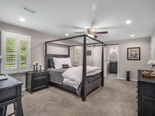 7119 Littlejohn Ln, Fairview, TN 37062 - bedroom with a barn door, recessed lighting, light colored carpet, baseboards, and a ceiling fan