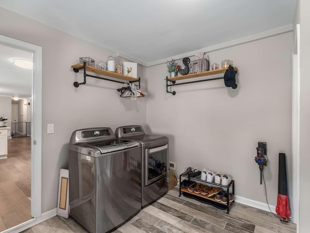 7119 Littlejohn Ln, Fairview, TN 37062 - laundry area with washing machine and dryer, light wood finished floors, and baseboards