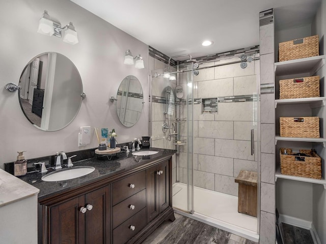 7119 Littlejohn Ln, Fairview, TN 37062 - bathroom featuring a shower stall, double vanity, and wood finished floors