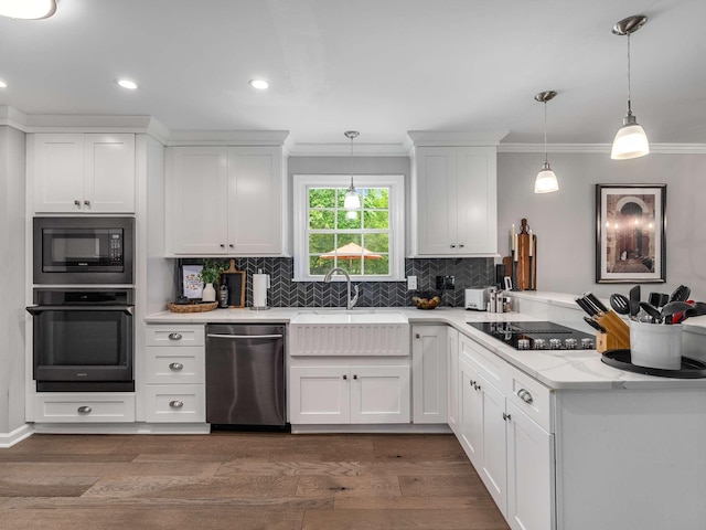 7119 Littlejohn Ln, Fairview, TN 37062 - kitchen featuring black appliances, a peninsula, ornamental molding, dark wood-type flooring, and tasteful backsplash