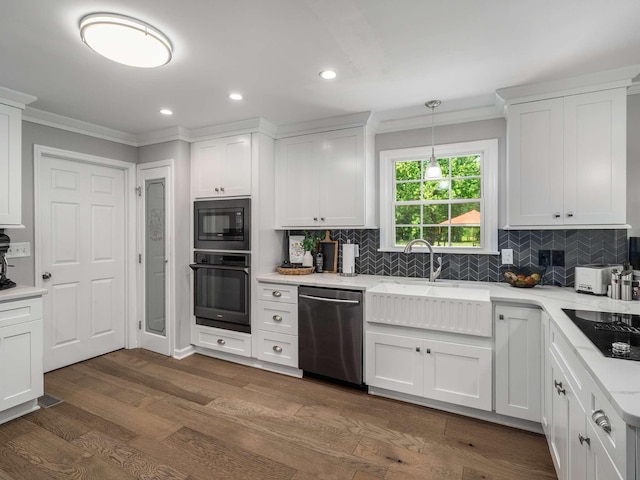 7119 Littlejohn Ln, Fairview, TN 37062 - kitchen with black appliances, crown molding, a sink, dark wood finished floors, and decorative backsplash