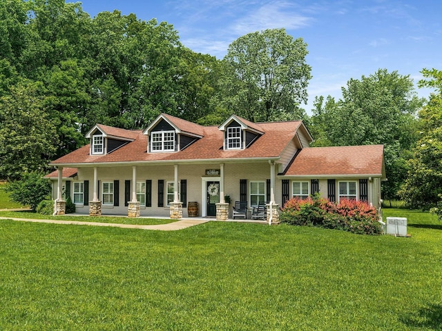 7119 Littlejohn Ln, Fairview, TN 37062 - cape cod-style house with a front lawn, covered porch, and roof with shingles