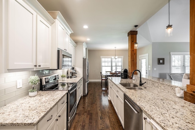 725B N Russell St, Portland, TN 37148 - kitchen with appliances with stainless steel finishes, a sink, dark wood finished floors, backsplash, and white cabinets