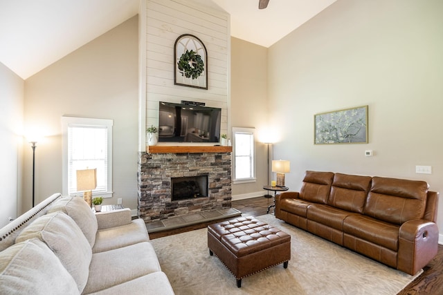 725B N Russell St, Portland, TN 37148 - living area with a stone fireplace, high vaulted ceiling, baseboards, and wood finished floors