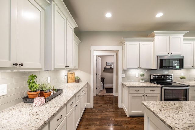 725B N Russell St, Portland, TN 37148 - kitchen with stainless steel appliances, tasteful backsplash, white cabinetry, dark wood-style floors, and recessed lighting
