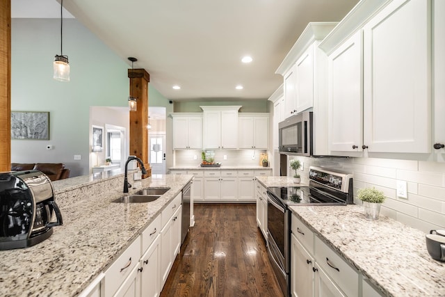 725B N Russell St, Portland, TN 37148 - kitchen with appliances with stainless steel finishes, a sink, tasteful backsplash, white cabinets, and dark wood-type flooring