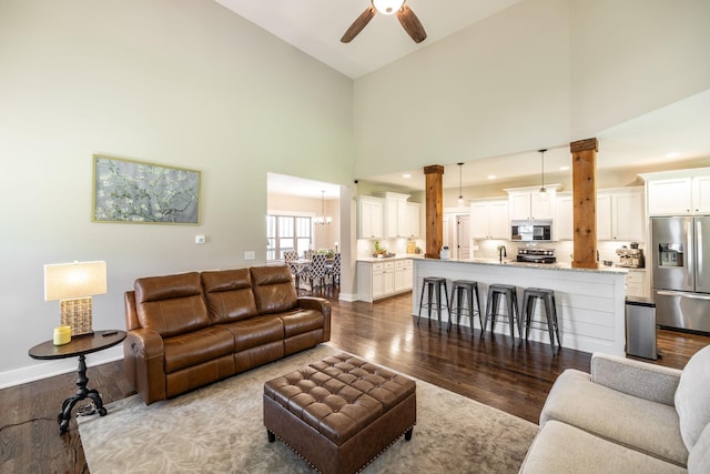725B N Russell St, Portland, TN 37148 - living room with dark wood finished floors, a ceiling fan, high vaulted ceiling, and baseboards