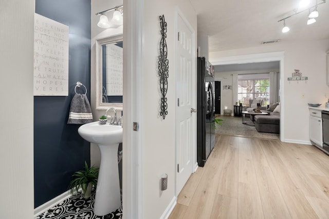2020 Caladonia Way, Smyrna, TN 37167 - bathroom featuring wood finished floors, baseboards, and a sink