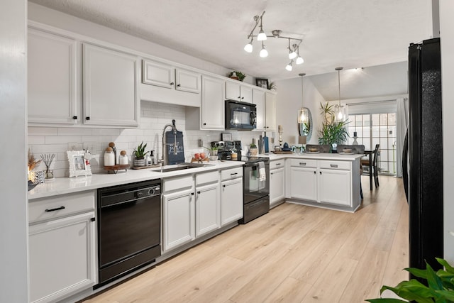 2020 Caladonia Way, Smyrna, TN 37167 - kitchen with black appliances, a sink, a peninsula, decorative backsplash, and white cabinets