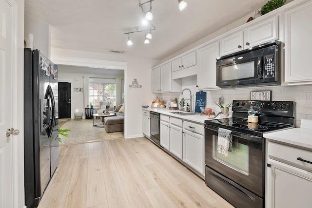 2020 Caladonia Way, Smyrna, TN 37167 - kitchen featuring black appliances, a sink, light countertops, white cabinets, and light wood finished floors