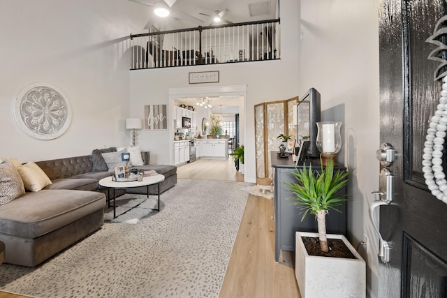2020 Caladonia Way, Smyrna, TN 37167 - living area featuring light wood-style flooring, ceiling fan, a high ceiling, and a chandelier