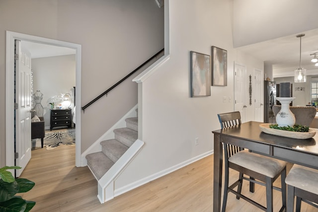 2020 Caladonia Way, Smyrna, TN 37167 - dining space featuring light wood finished floors, stairway, and baseboards