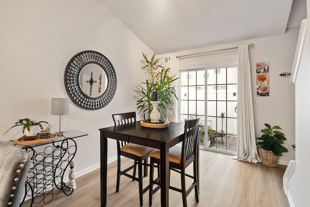 2020 Caladonia Way, Smyrna, TN 37167 - dining area featuring vaulted ceiling, light wood-style floors, baseboards, and a textured ceiling